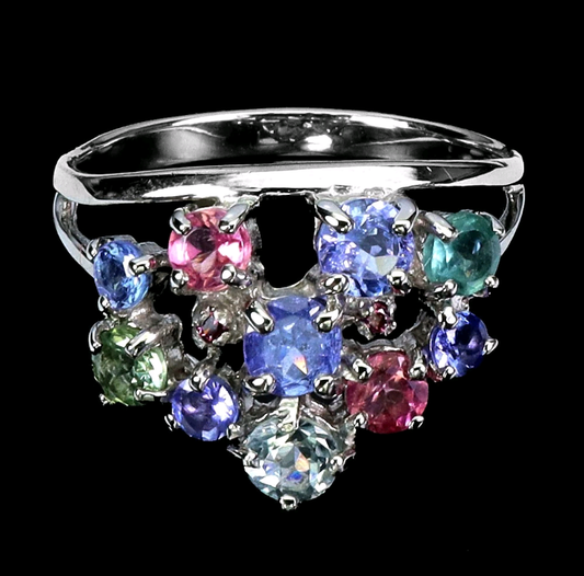 Silver ring with multicolored gemstones on a black background