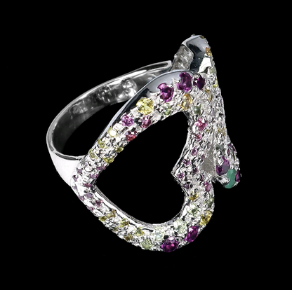 Silver ring with multicolored gemstones on a black background