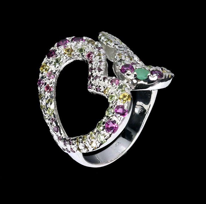 Silver ring with multicolored gemstones on a black background
