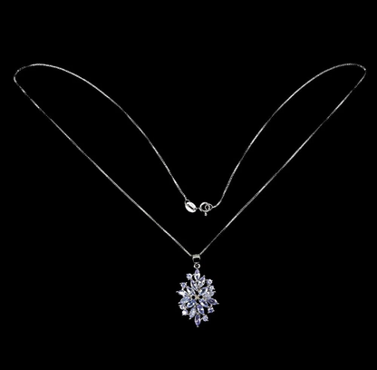 Silver necklace with a snowflake pendant on a black background