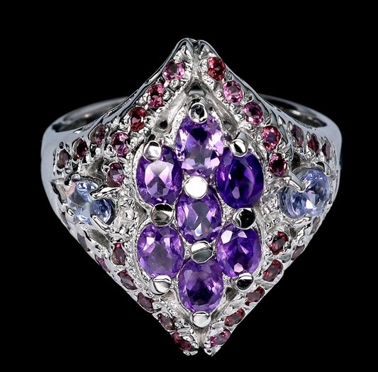 Ring with purple gemstones and silver accents on a black background