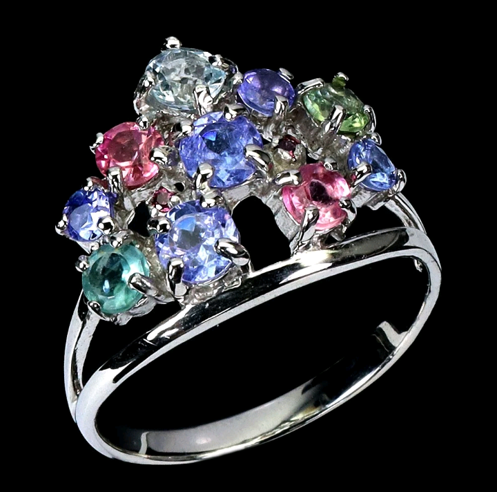Silver ring with multicolored gemstones on a black background
