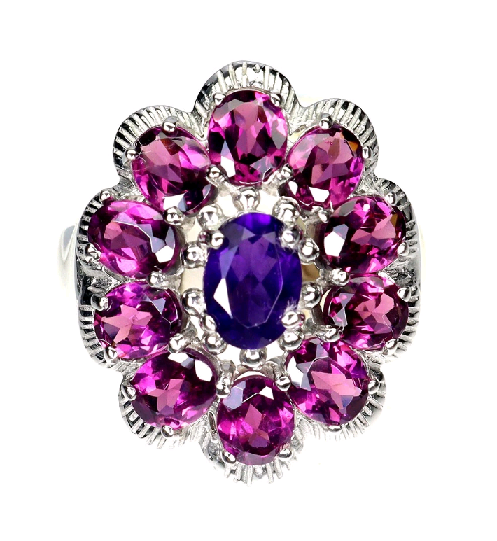 Ring with pink gemstones and a purple center on a white background