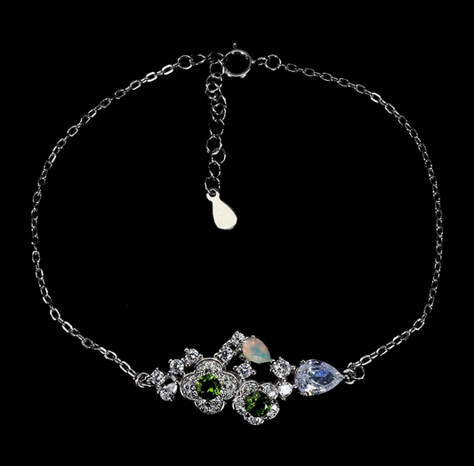 Silver bracelet with gemstones on a black background